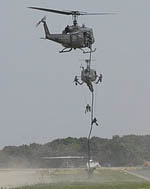 Troops fast-roping from a UH-1D