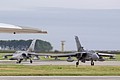 A pair of RAF Lossiemouth based 12 Squadron Tornado GR.4 framed by the wing of the Vulcan as they clear the runway.