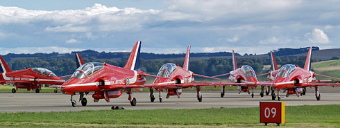 The Runway Marker says 09 but only seven of the nine Red Arrows Hawk T.1 are in frame here as they leave the runway after landing.