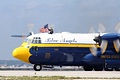 U.S. Navy Blue Angels C-130 'Fat Albert' crew member waiving the flag