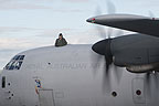 RAAF C-130J crew member looking out of the top hatch