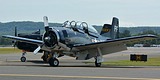 T-28 Trojan restored in USN c/s, behind it another example in USMC c/s