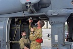 Officer from the 56th Rescue Squadron displays how to fit the rescue quick strop to the helicopter hoist hooks