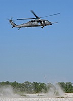 Fight engineer operates the hoist device to simulate a personnel recovery. The HH-60G rescue equipment includes a hoist capable of lifting a 270 kilograms load (600 pound) from a hover height of 60.7 meters (200 feet)