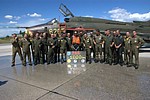 Italian and Polish pilots posing for the picture to commemorate the 1,000 hours achievement of their colleague.