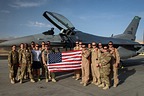 Lt. Col. Vince O’Connor, the commander of the 555th Expeditionary Fighter Squadron, holds the American flag with members of the 555th EFS at Bagram Airfield, Afghanistan, May 19, 2017, after surpassing 2,000 career flight hours. (U.S. Air Force photo by Staff Sgt. Benjamin Gonsier)